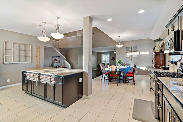 kitchen with dark brown cabinetry, light stone counters, vaulted ceiling, appliances with stainless steel finishes, and pendant lighting