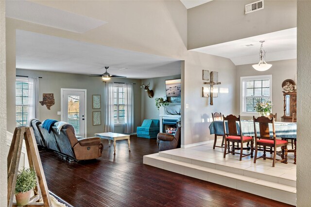 living room featuring a fireplace, ceiling fan, hardwood / wood-style floors, and a healthy amount of sunlight