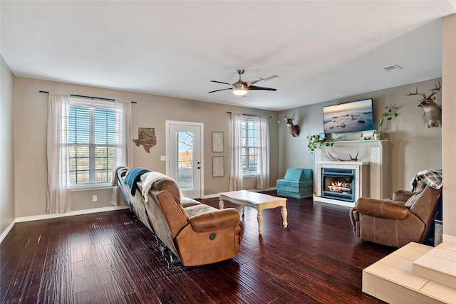 living room featuring wood-type flooring and ceiling fan