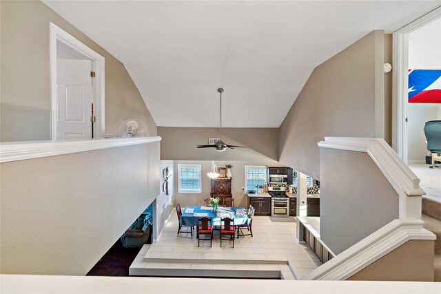 carpeted bedroom featuring ceiling fan and vaulted ceiling