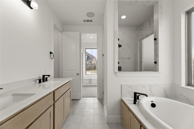 bathroom with vanity and separate shower and tub