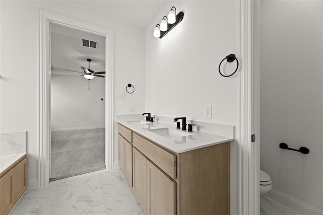 bathroom featuring vanity, toilet, and ceiling fan