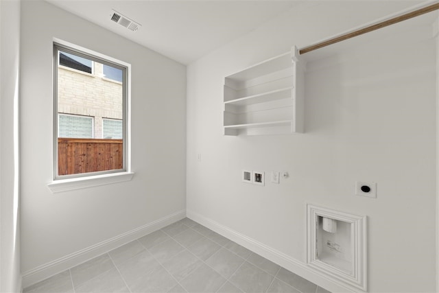 clothes washing area with hookup for a washing machine, gas dryer hookup, and electric dryer hookup