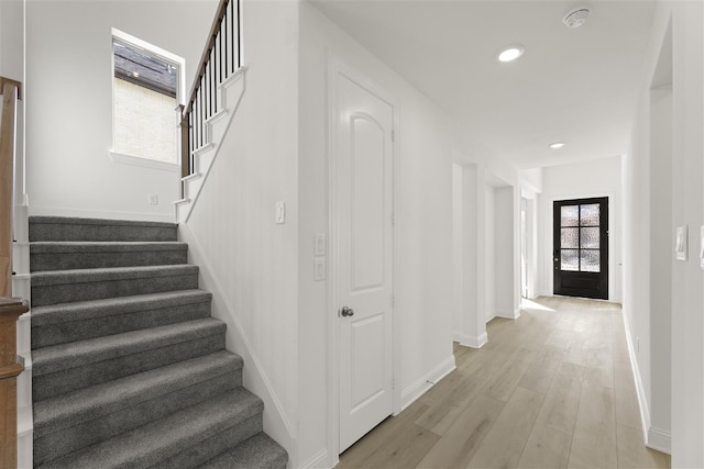 stairway with hardwood / wood-style flooring