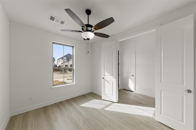 unfurnished bedroom with ceiling fan and light wood-type flooring