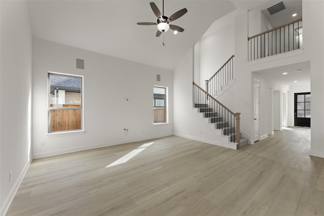 unfurnished living room featuring light hardwood / wood-style floors, high vaulted ceiling, and ceiling fan