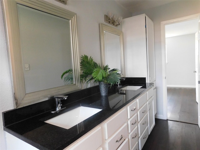 bathroom with vanity and wood-type flooring