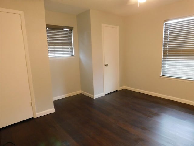 unfurnished bedroom with dark hardwood / wood-style flooring