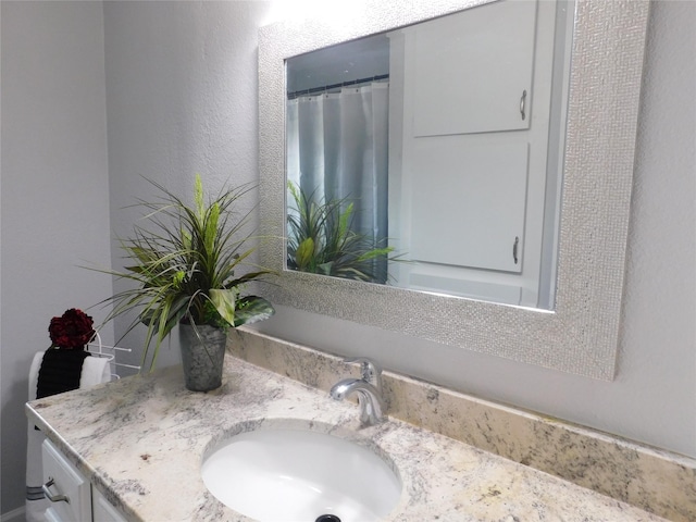 bathroom featuring vanity and walk in shower