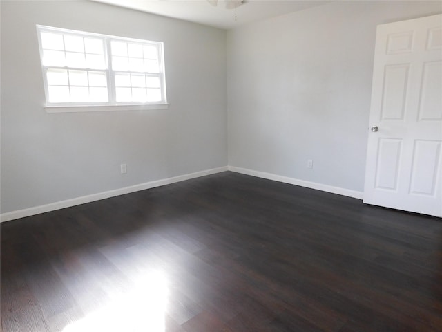 unfurnished room with ceiling fan and dark hardwood / wood-style floors