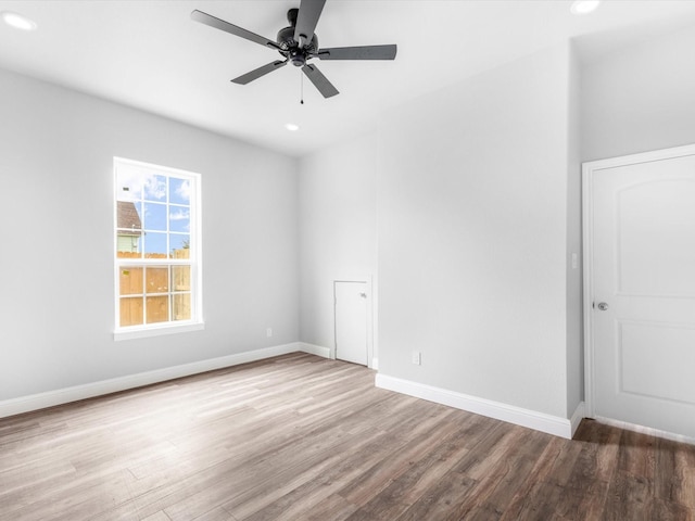 spare room featuring light hardwood / wood-style floors and ceiling fan