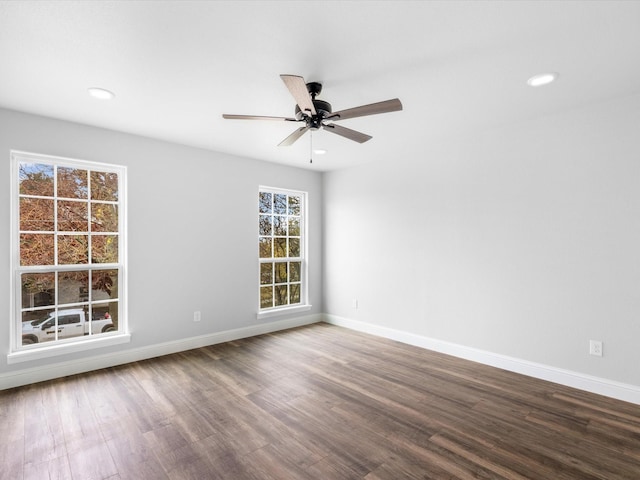 spare room featuring wood-type flooring and ceiling fan