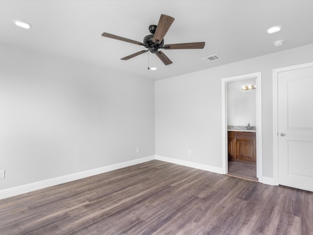 unfurnished room featuring ceiling fan, dark hardwood / wood-style flooring, and sink