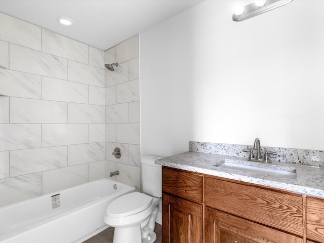 full bathroom with vanity, toilet, and tiled shower / bath combo