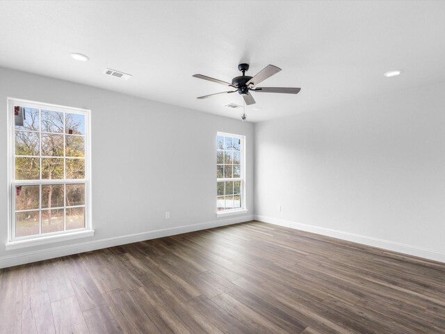 unfurnished room featuring ceiling fan and dark hardwood / wood-style flooring