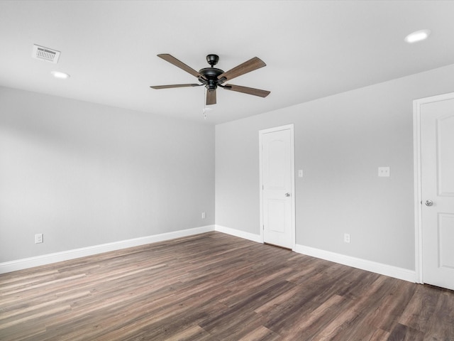 empty room with ceiling fan and dark wood-type flooring