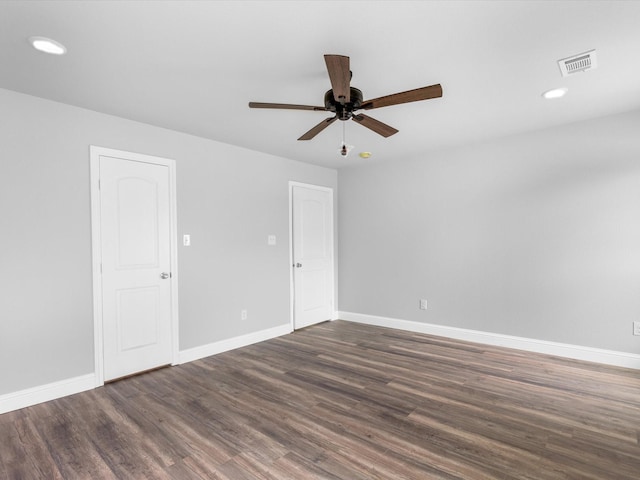 empty room featuring ceiling fan and dark wood-type flooring