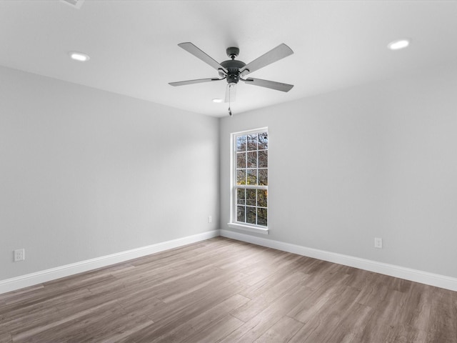 spare room with hardwood / wood-style flooring and ceiling fan