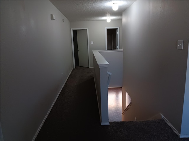 hall featuring a textured ceiling