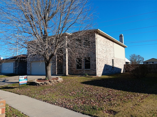 view of front of house with a garage and a front lawn