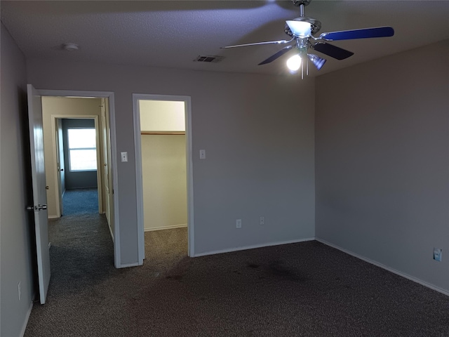 spare room featuring ceiling fan and carpet floors