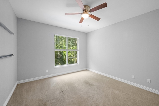 spare room featuring baseboards, carpet, and a ceiling fan