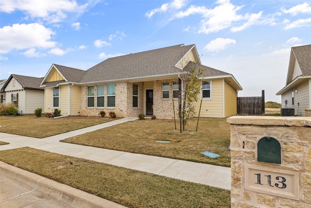 ranch-style home with central AC and a front lawn