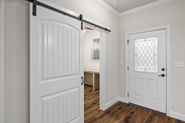 entrance foyer with dark hardwood / wood-style flooring, a barn door, and ornamental molding