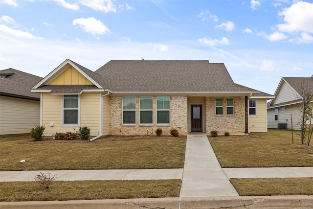 view of front of property featuring central air condition unit and a front lawn