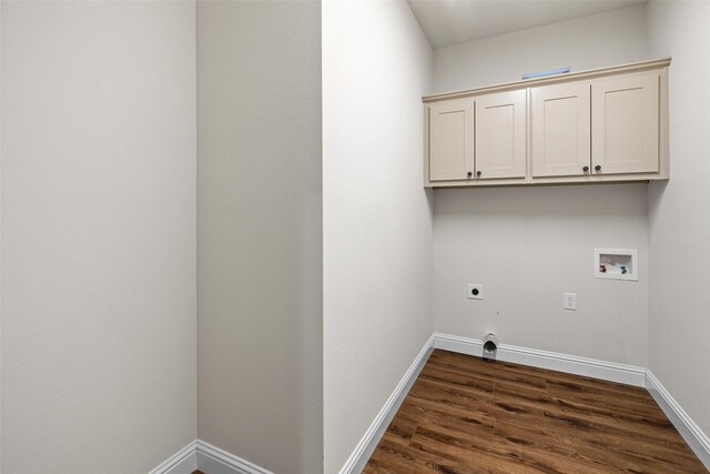 clothes washing area with hookup for an electric dryer, washer hookup, cabinets, and dark wood-type flooring