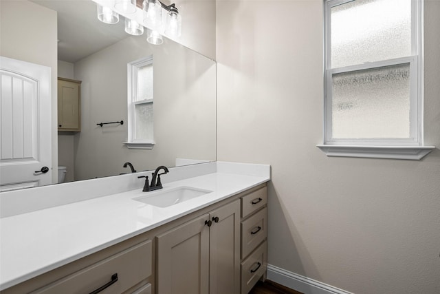 bathroom featuring vanity and toilet