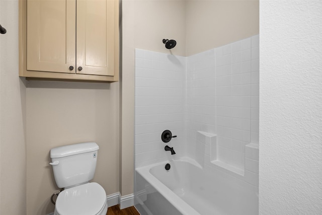 bathroom featuring wood-type flooring, shower / bath combination, and toilet