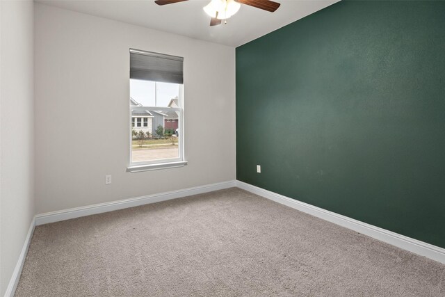 unfurnished room featuring carpet floors and ceiling fan