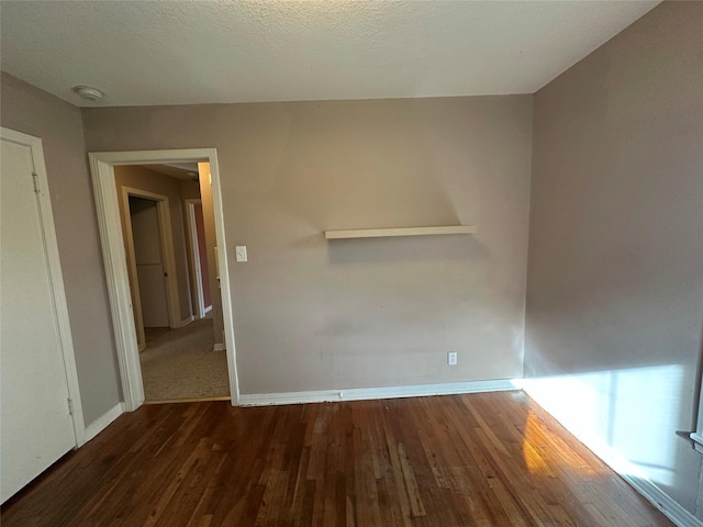 spare room with dark wood-type flooring