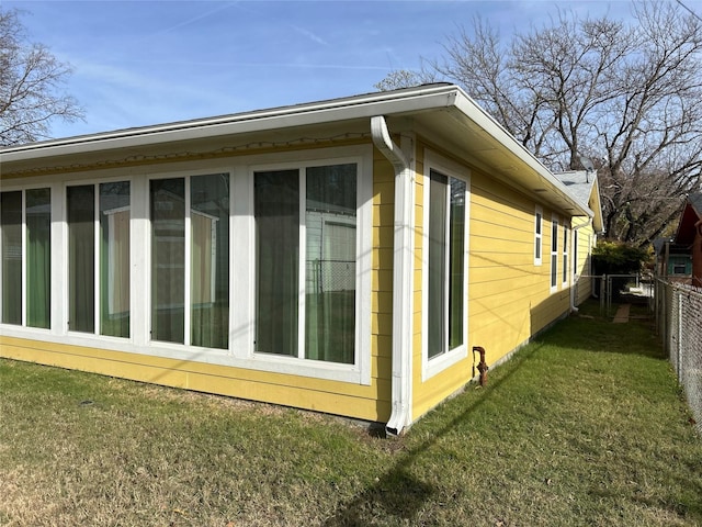 view of side of home featuring a lawn