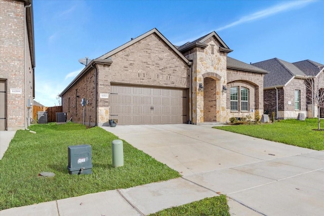 view of front of house featuring a garage, central AC unit, and a front lawn