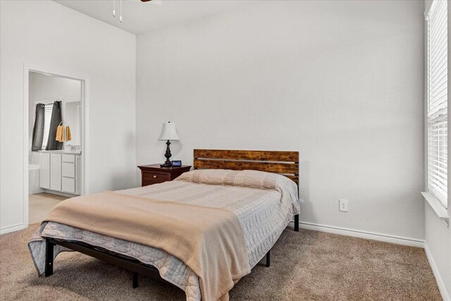 carpeted bedroom featuring ensuite bath