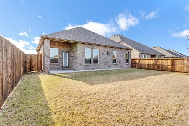 back of house with a lawn