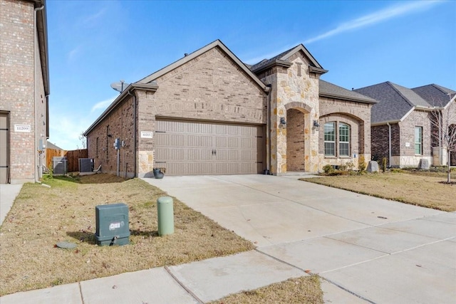 view of front of home with central AC and a garage