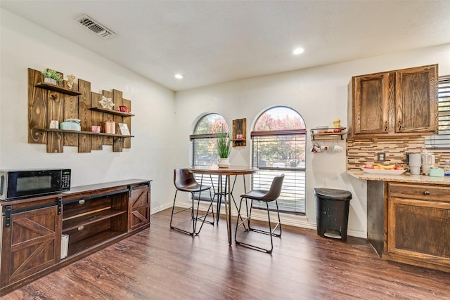 dining space featuring dark hardwood / wood-style flooring