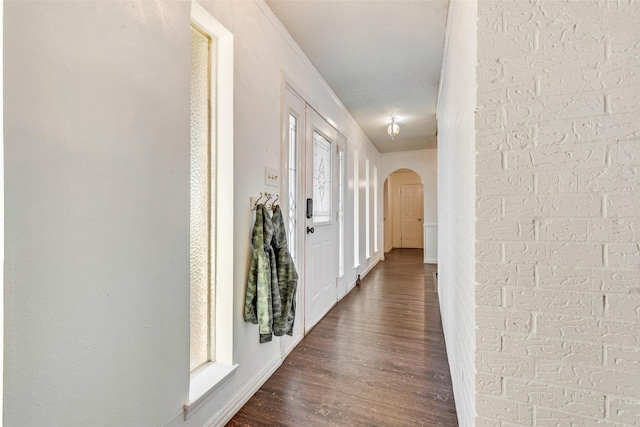 corridor with dark hardwood / wood-style flooring