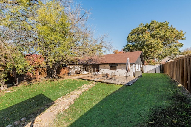 view of yard featuring a patio area and central air condition unit