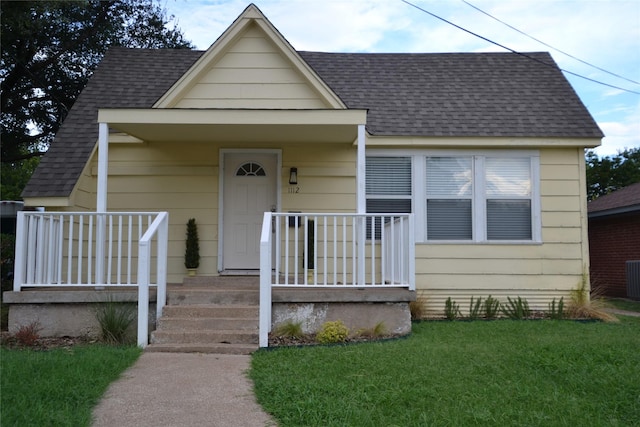 bungalow featuring a front lawn and a porch