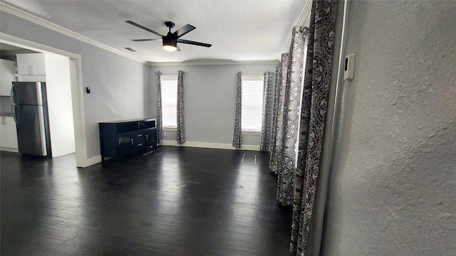 unfurnished living room featuring crown molding, ceiling fan, and dark hardwood / wood-style floors