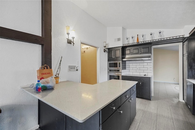 kitchen with backsplash, vaulted ceiling, a textured ceiling, kitchen peninsula, and stainless steel appliances