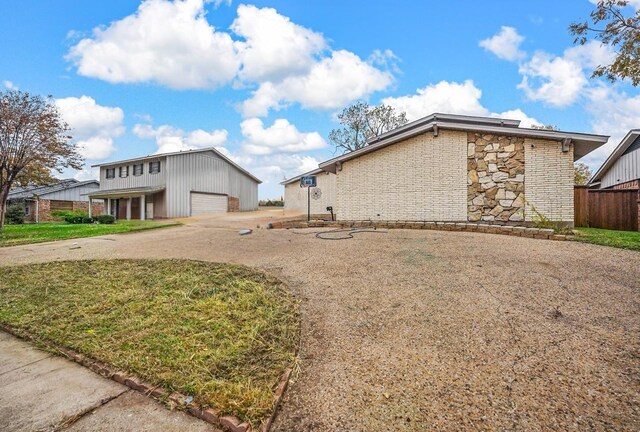 view of home's exterior with an outdoor structure and a garage