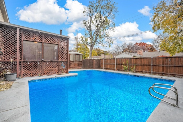 view of swimming pool with a sunroom