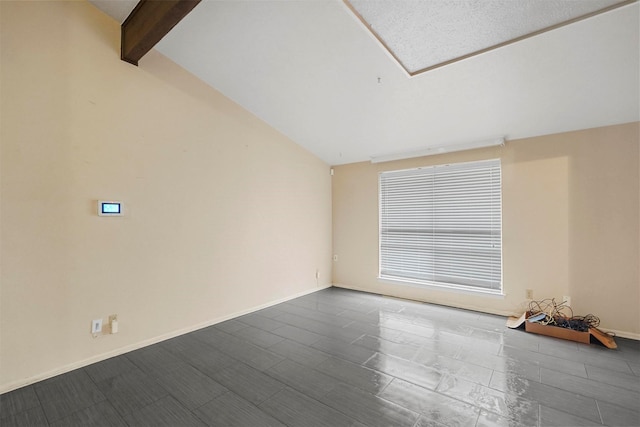 unfurnished room with vaulted ceiling with beams