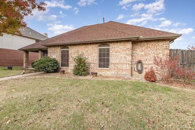 rear view of house featuring a yard