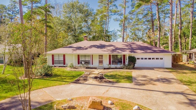 ranch-style home with a front yard, a porch, and a garage